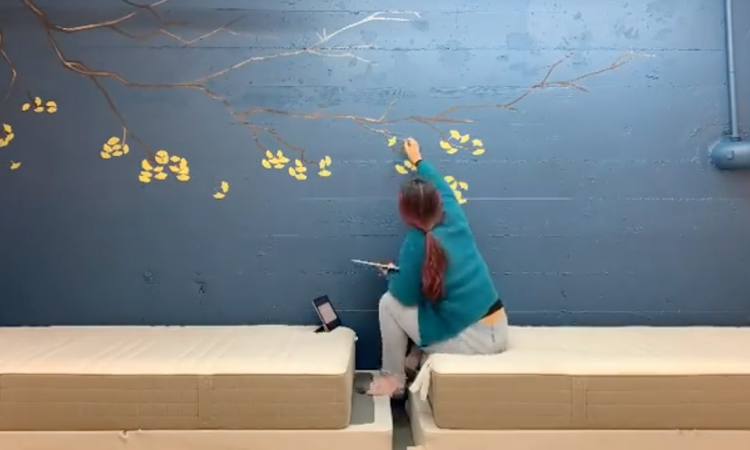 Alice Chu painting the mural