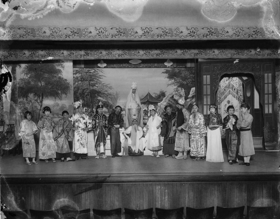 Ensemble of actors in a play with Kwan Yin, goddess of mercy at the Great Star Theatre